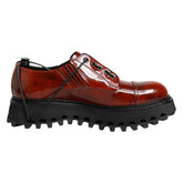 Brown leather shoe with thick black sole on a white background